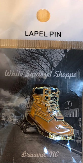 Lapel pin in the shape of a hiking boot.