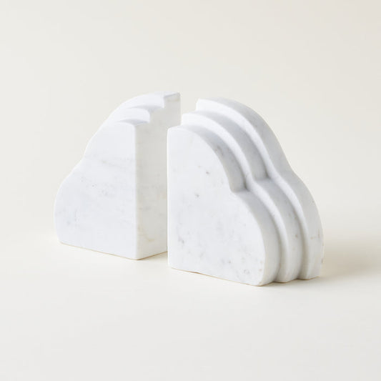 Set of 2 cloud-shaped white marble bookends on a light background. Home decor styled for a kid's room or living room bookshelf.